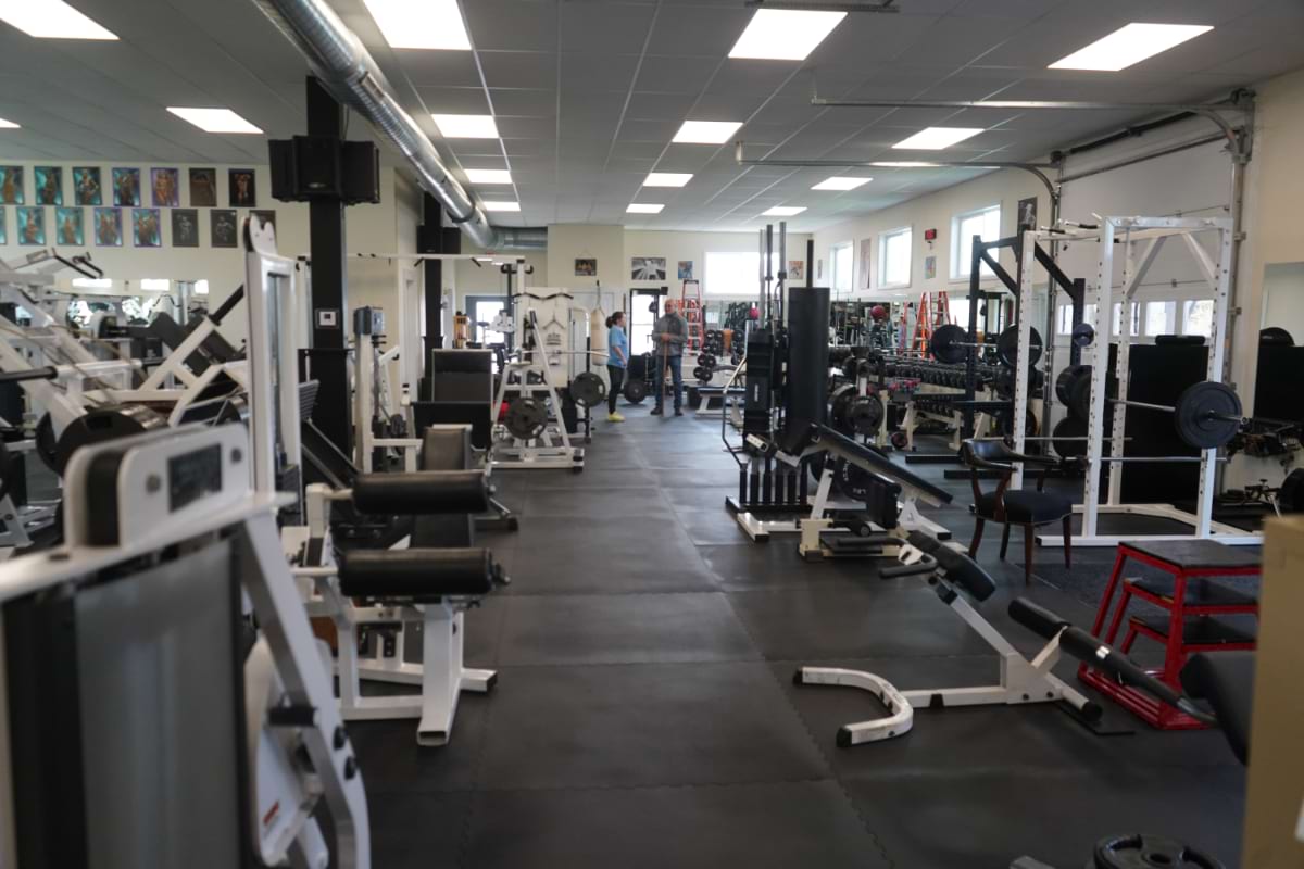 Trabucco Fitness training floor — racks, benches, and free weights